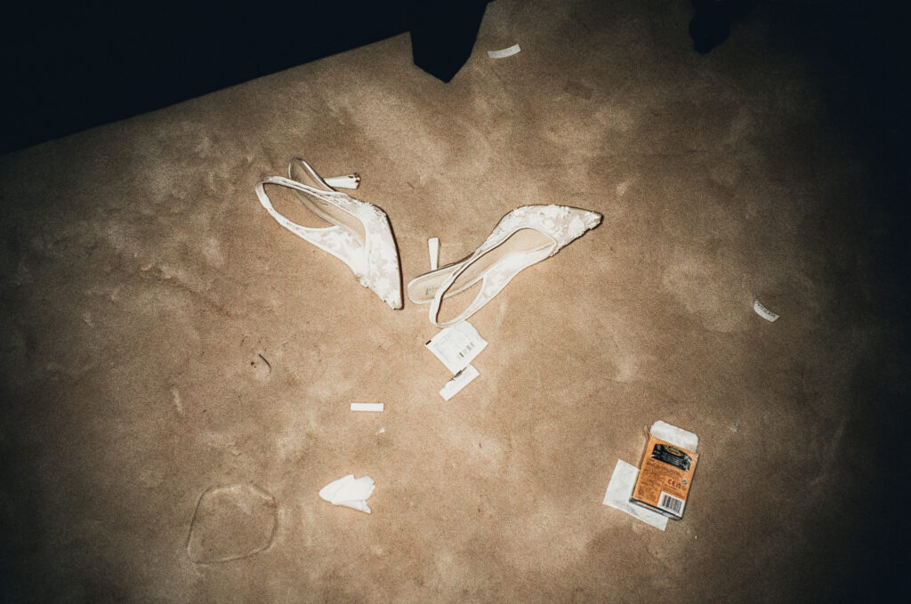 Bride's shoes and confetti on dance floor at night