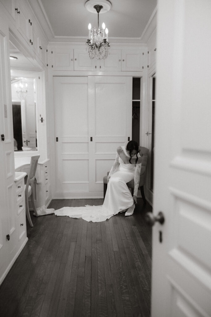 Bride sitting in dressing room before ceremony, editorial wedding photography