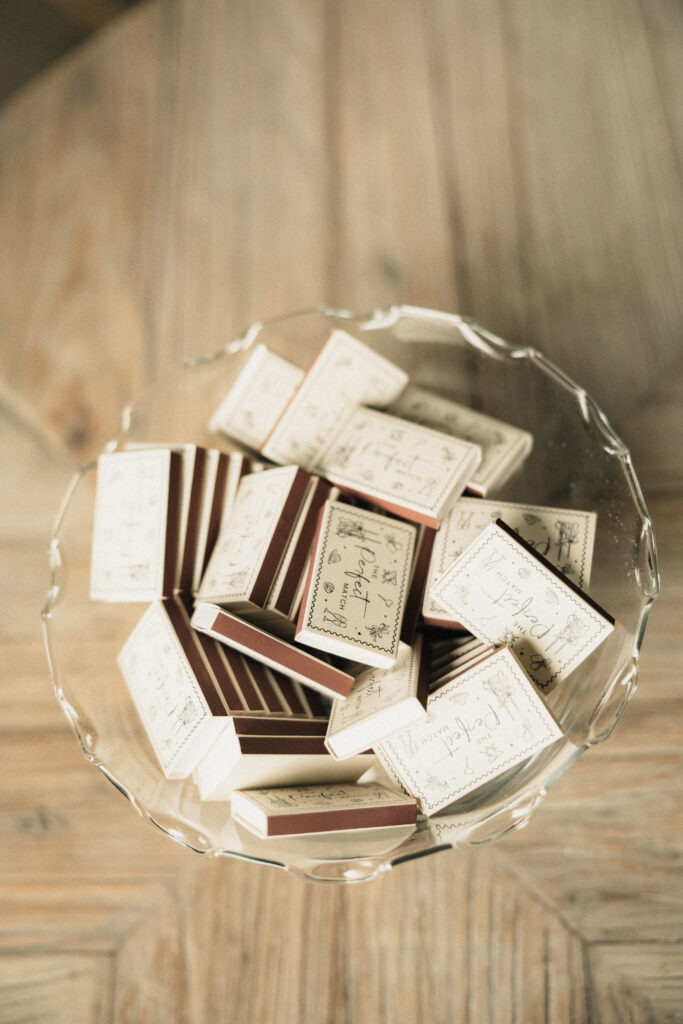 Personalized wedding favor matchboxes in glass dish