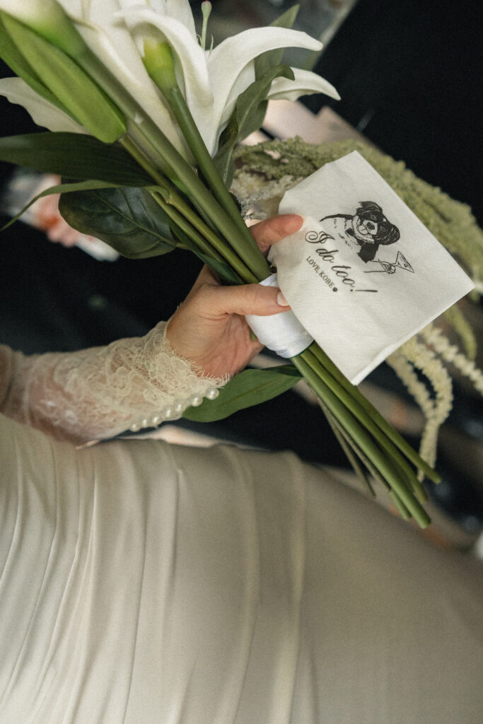 Calla lily bouquet detail with custom wedding cocktail napkin