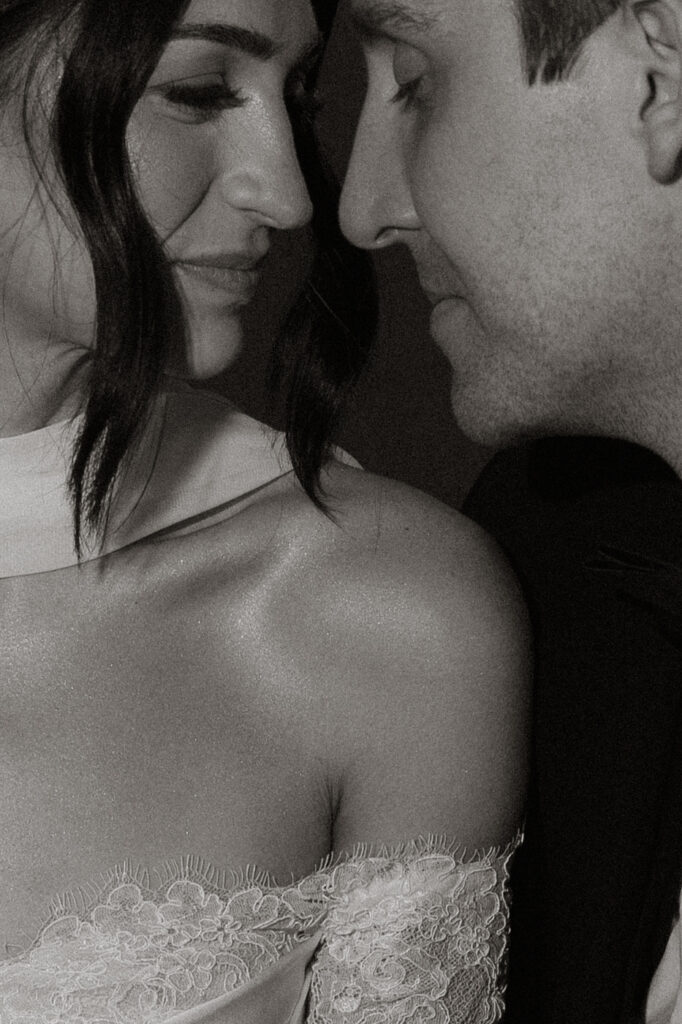 Bride and groom nose to nose, intimate black and white portrait